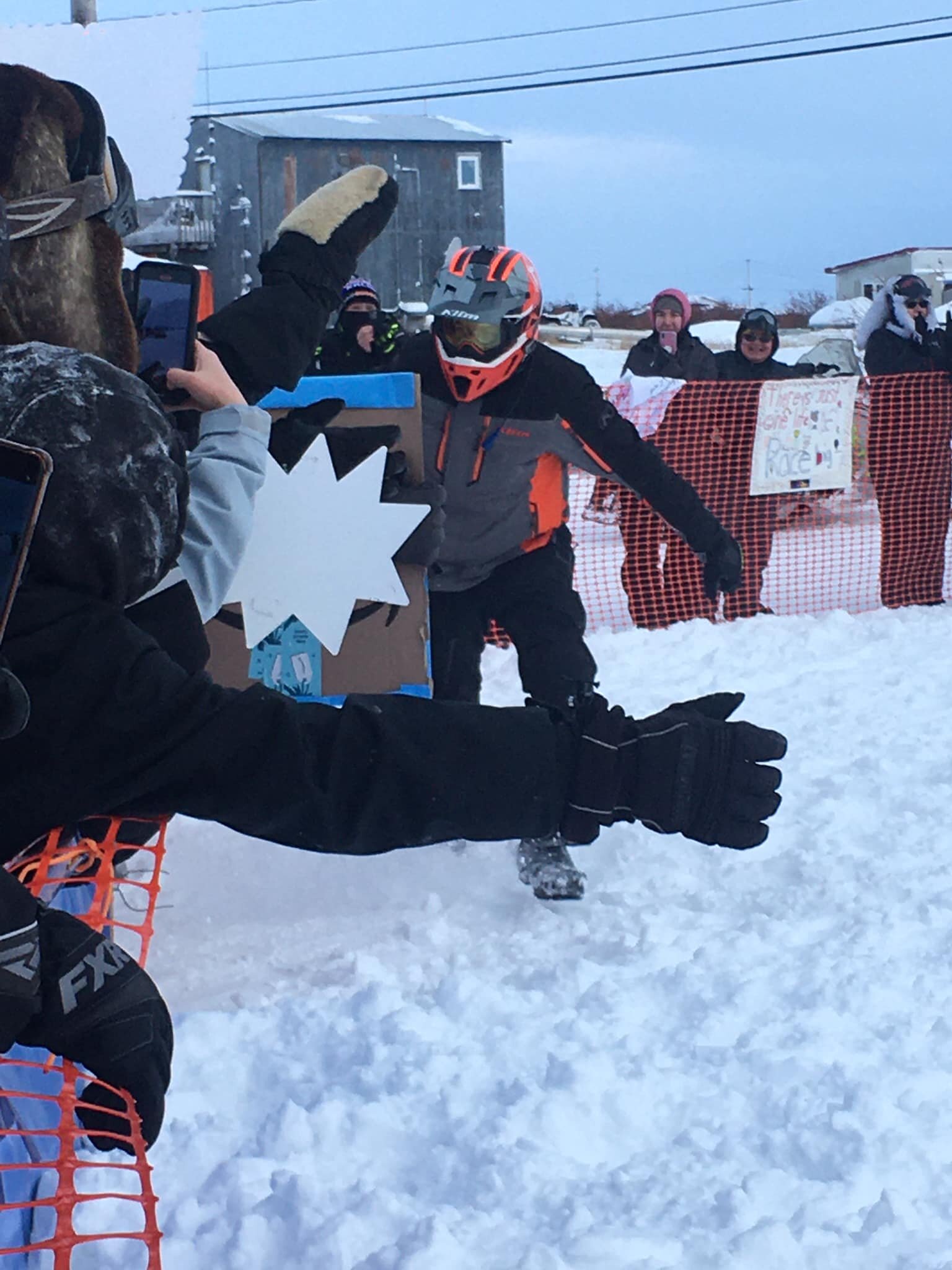 In Selawik, Team 10 high-fives every spectator out to greet the racers. Source: Iron Dog Facebook Group / Merilee Rena