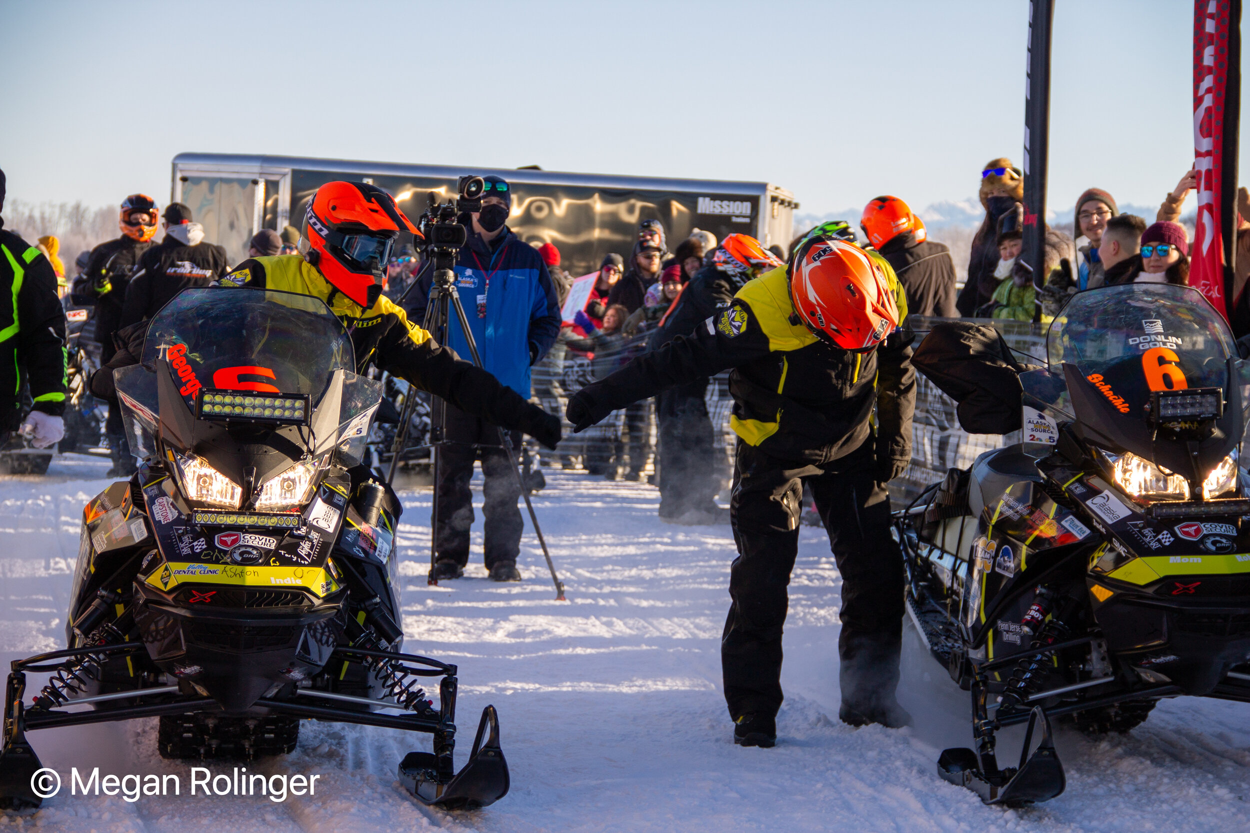 Team 6, Brad George and Robby Schachle, fist-bump at the start of Iron Dog 38. The pair holds a narrow lead at the halfway point. Photo: Megan Rolinger