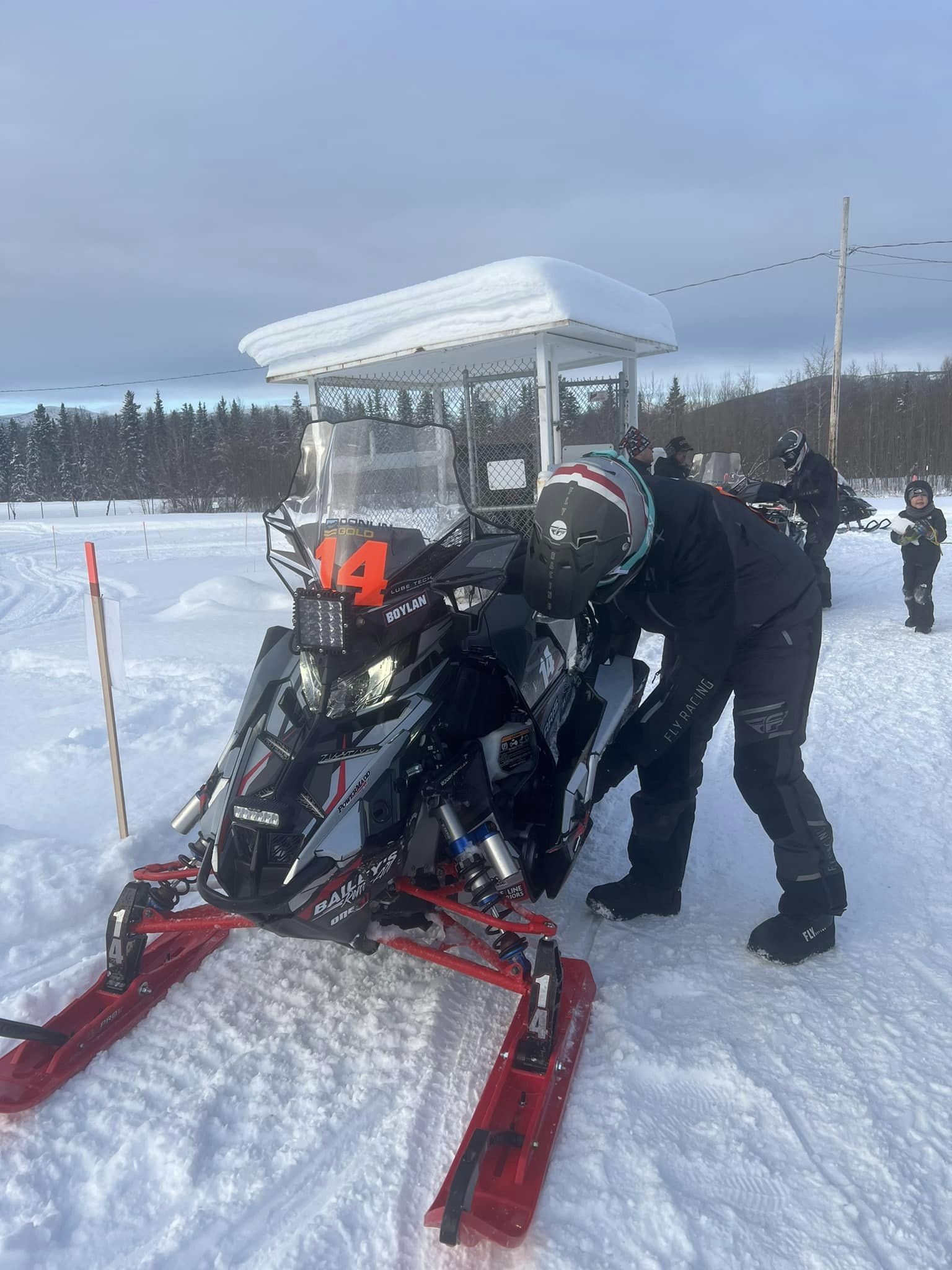 Team 14’s Casey Boylan checks his sled during a refuel at the Kaltag checkpoint. Trinity Viveiros photo.