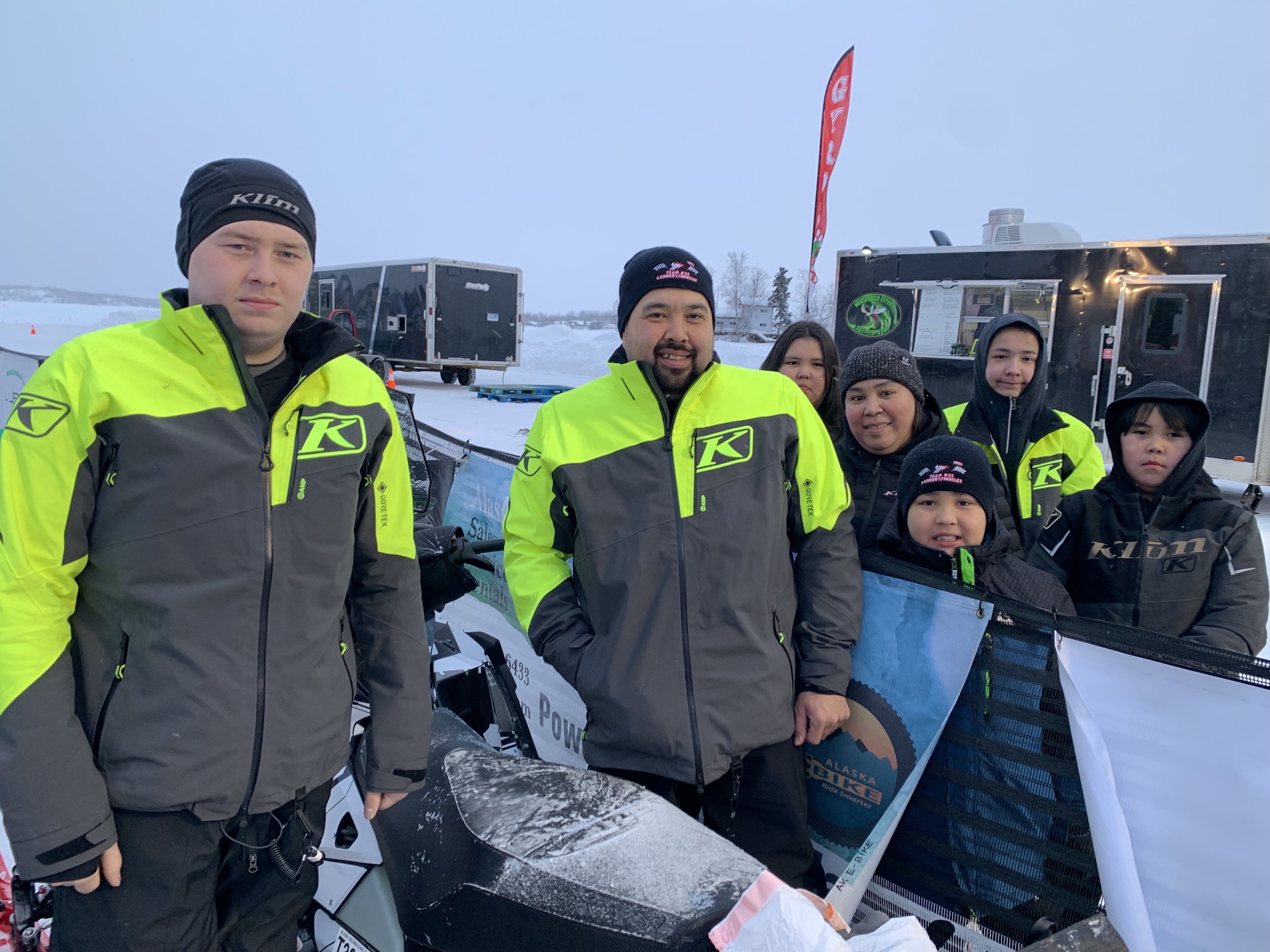 Team 33 racers Michael Hensley and George “Radar” Lambert flanked by Lambert’s family at the start of Iron Dog 2023 on Friday, Feb. 17, 2023. Unfortunately, Hensley suffered a back injury early in the race and the Kotzebue duo had to scratch.