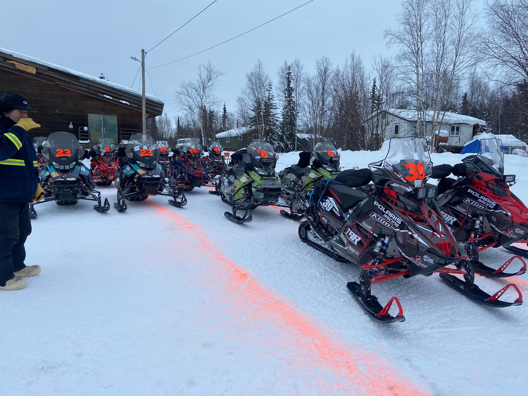 Sleds are staged in the Galena parking area for their Sunday morning departure. By Sunday evening, the front-runners had arrived in Unalakleet. Courtesy Shirley Cleaver