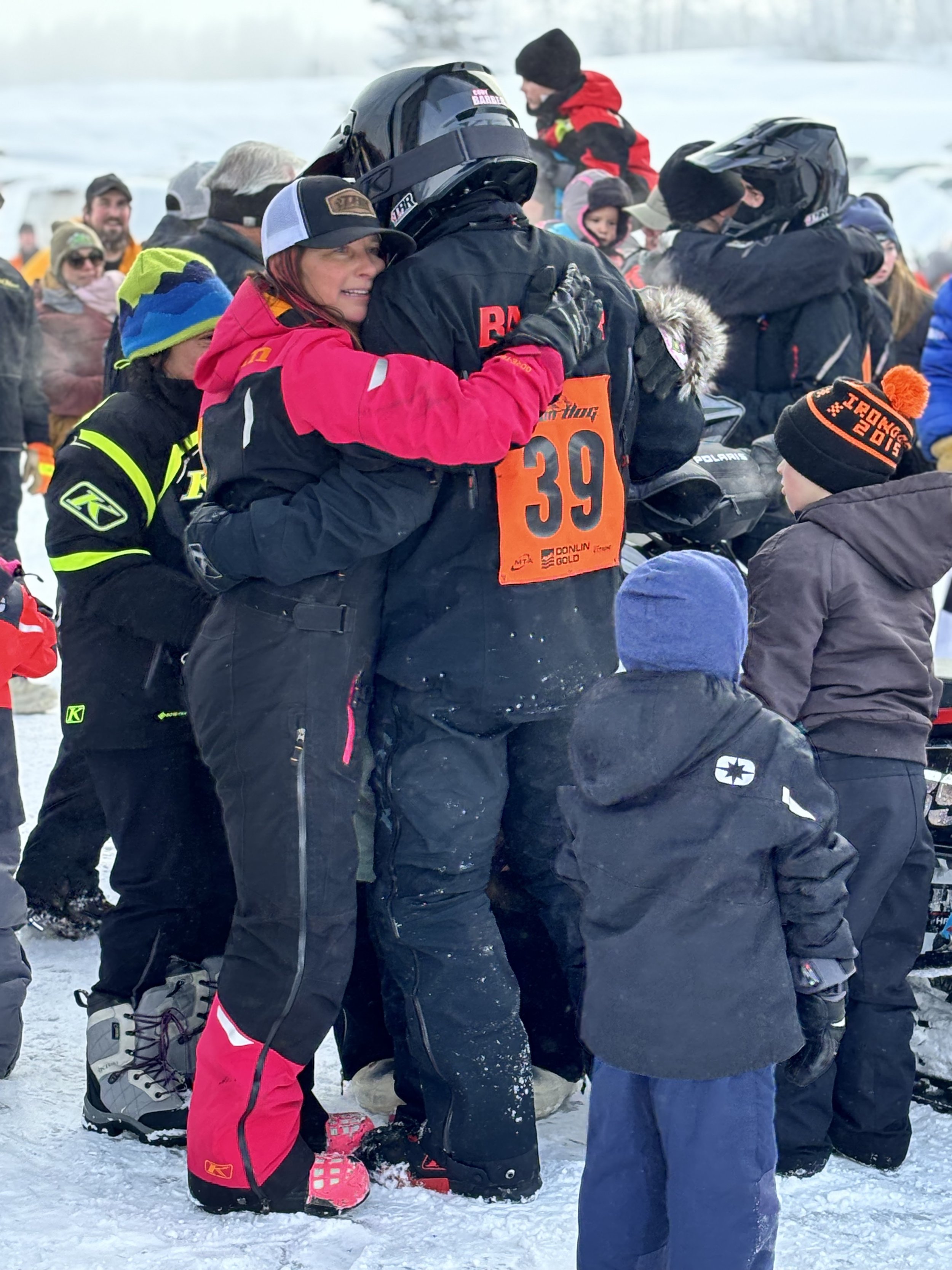 Tammy Barber embraces her son Cody after his victory in the 2024 Iron Dog. The Barber family has been racing for more than 25 years and includes Barber’s husband, Shane, and sons Cody and Evan. Tammy Barber’s father, Mike Spain, is also a longtime racer and Iron Dog veteran.