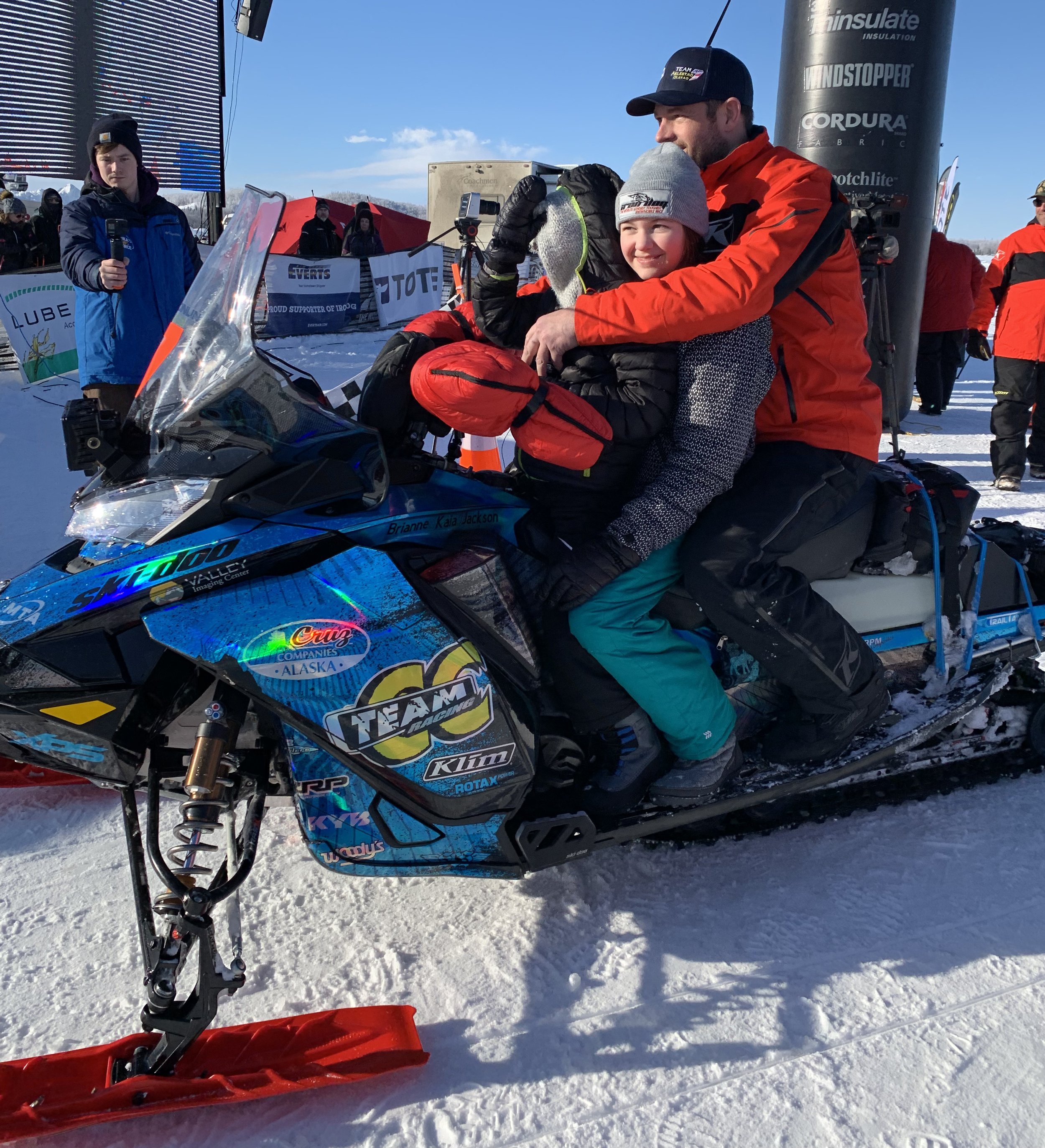 Nick Olstad gives his kids Jackson and Kaia a ride into the paddock for post-race inspection on Saturday. This is Olstad’s sixth Iron Dog victory. Iron Dog photo