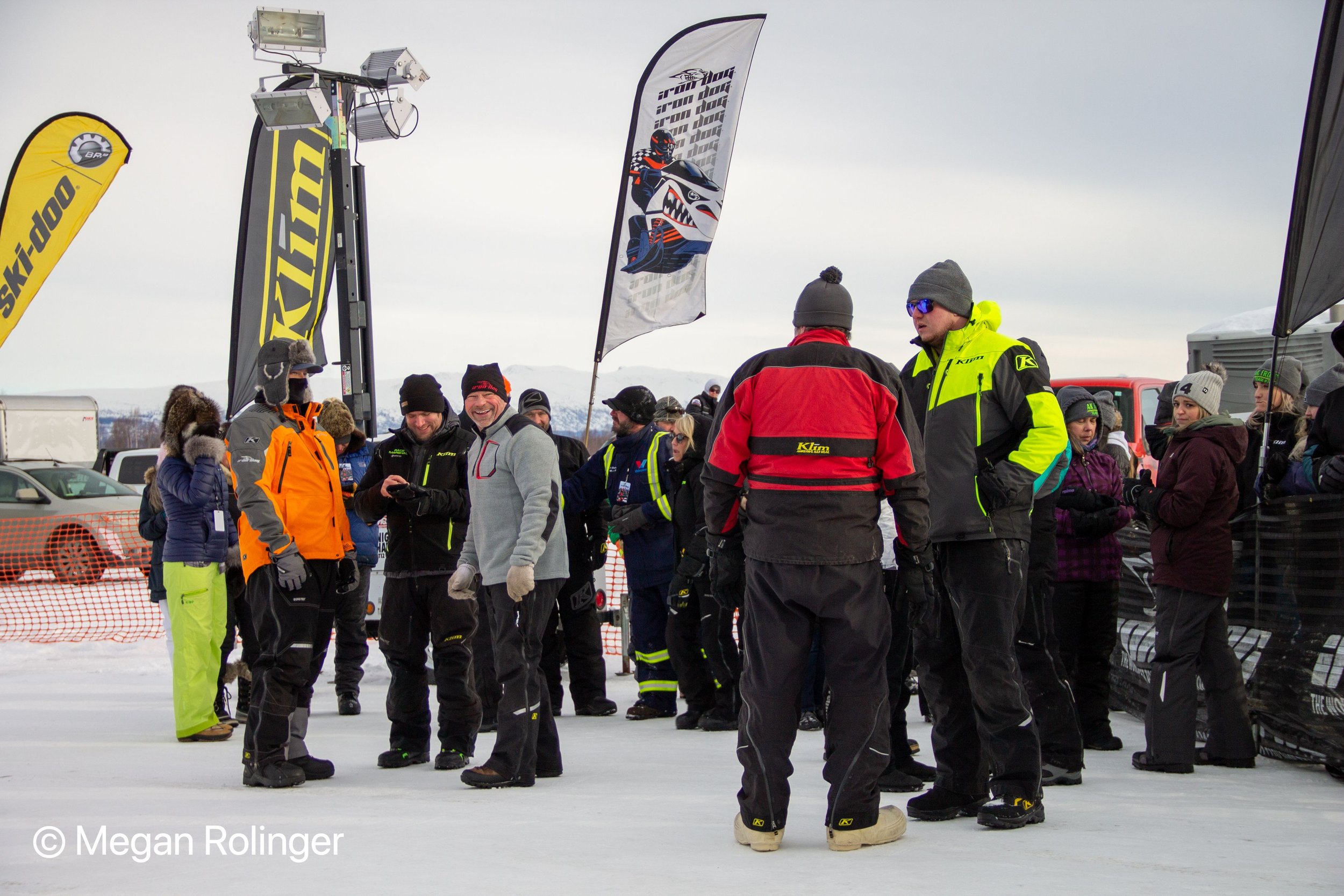 Mike Vasser, in gray, with 2021 race marshals Brian Webb and Geoff Crouse awaiting the 2021 finishers. Vasser is Iron Dog’s new executive director.