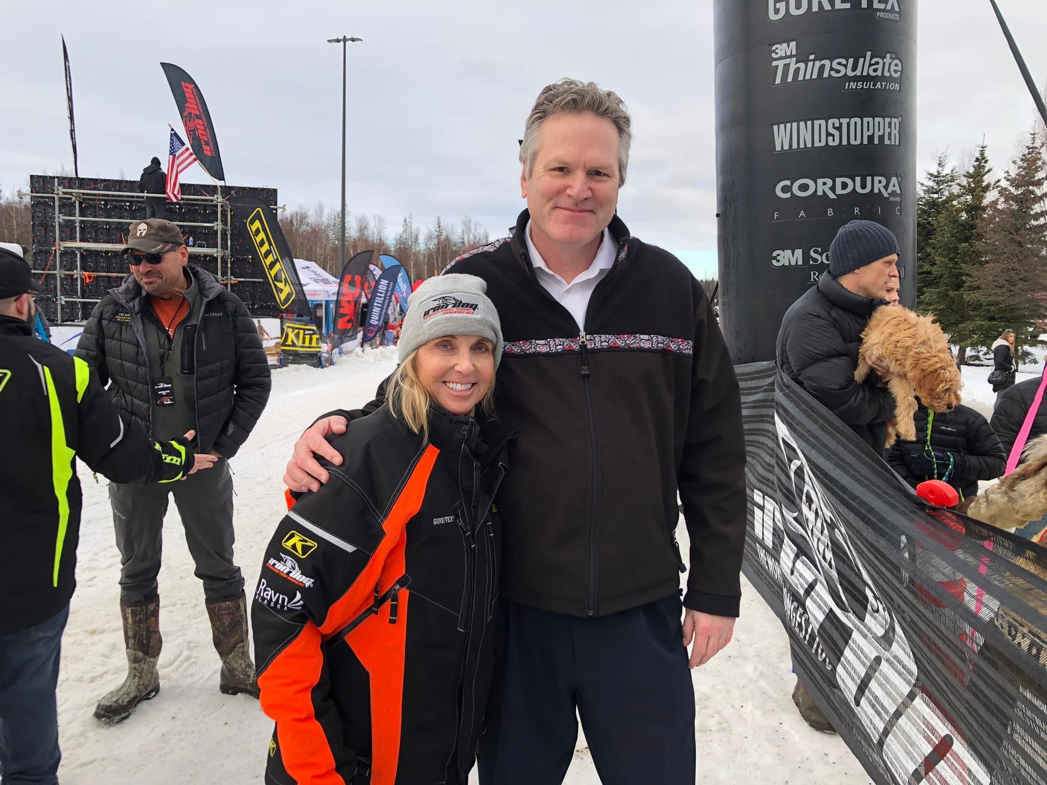 Kelli Cherrier Reagan, Iron Dog Operations Manager, with Gov. Dunleavy at the finish of the 2022 Iron Dog.